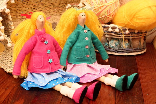 Two handmade dolls girlfriends tilda girls with long hair yellow to green and pink jacket and blue skirt and pink