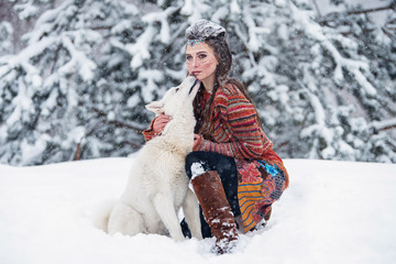 Native indian woman with traditional makeup and hairstyle in snowy winter. Beautiful girl in ethnic...