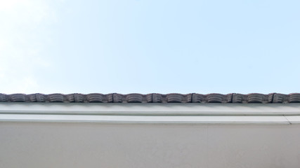 under the Roof of a House with Blue Sky background