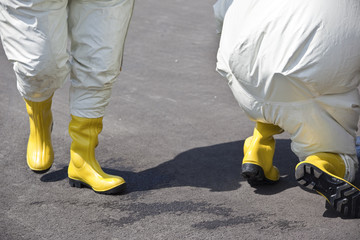 Two men in protective gear as protection against contamination with radioactive particles