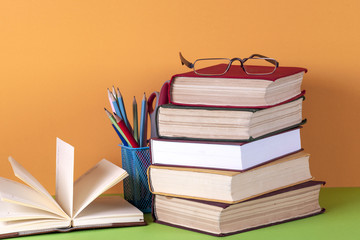 Open book, hardback bookson bright colorful background.