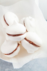 Meringue cookies with chocolate on white background