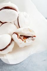 Meringue cookies with chocolate on white background