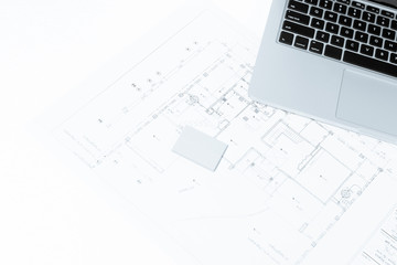 notebook over house construction blueprint with blue tone effect