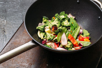 Cooking Asian wok with stir fry chicken and vegetables Chinese food Top view