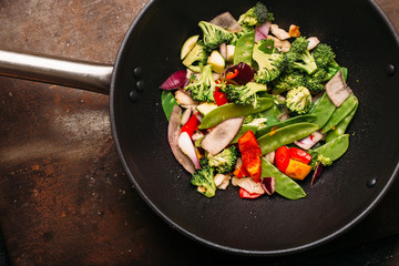 Cooking Asian wok with stir fry chicken and vegetables Chinese food Top view