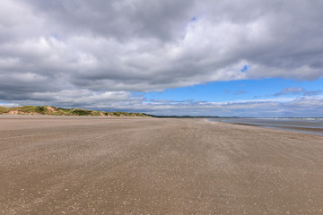 Fototapeta na wymiar Scenic view of beach against blue cloudy sky, Murlough Beach, Newcastle, Northern Ireland