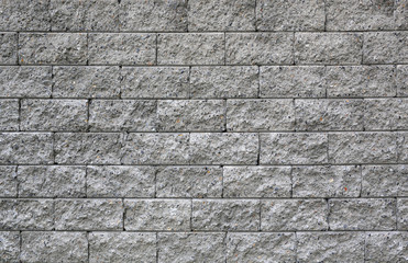Abstract background of grey or gray brick wall.