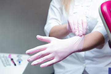 A young female doctor preparing herself for working, putting on