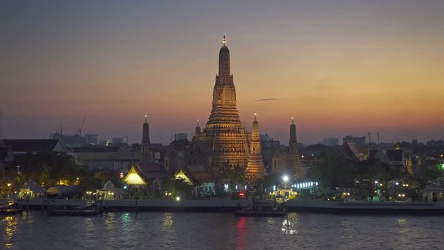 Landscape with Wat Arun at twilight time. Buddhist temple located along the Chao Phraya river in Bangkok, Thailand  4k
