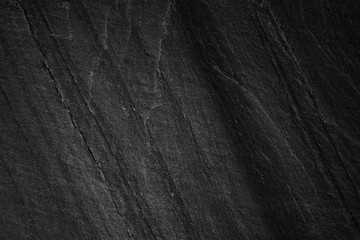 Dark grey black slate background or natural stone texture.