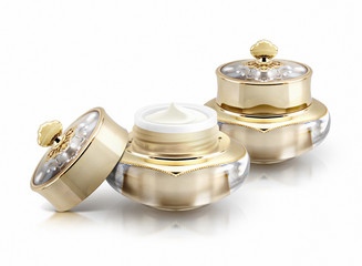 Two golden crown cosmetic jar on white background
