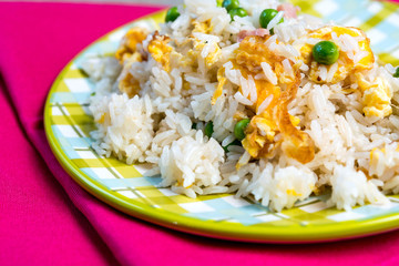 Homemade Chinese fried rice with vegetables and fried eggs
