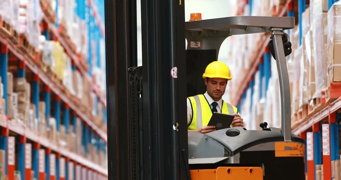 Male warehouse worker using digital tablet