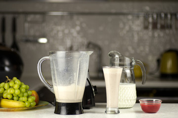 preparing a milk coctail with fruits in the kitchen.