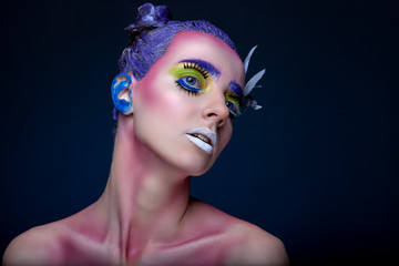 Creative portrait of woman with art make-up.