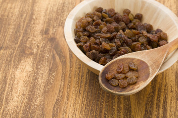 Raisins on a wooden spoon