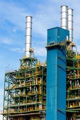 Refinery tower in petrochemical industrial plant with cloudy sky
