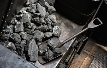 Shovel and coal in historic steam locomotive