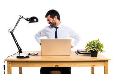Businessman in his office with back pain