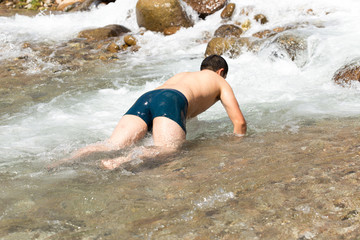 man bathes in a cold mountain water