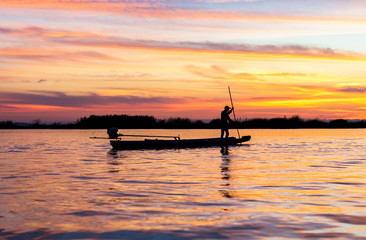 Fototapeta na wymiar fishermen in boat on morning sunrise