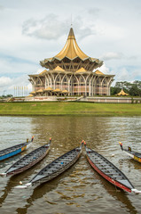 Kuching, Malaysia, Parliament building and longboats under the water festival regatta.