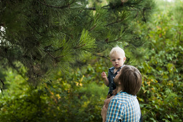 father and son under a pine branch