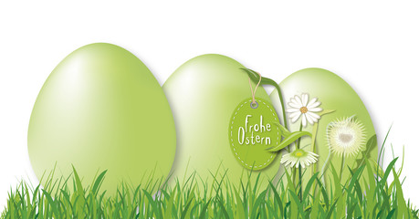 Grüne Ostereier im Gras mit Blumendeko und Anhänger