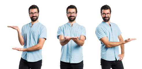 Handsome man with blue glasses presenting something