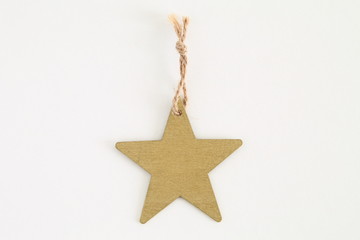 Red wooden star shaped tag with rope isolated on white