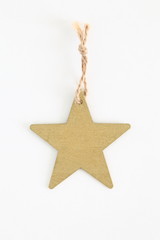 Red wooden star shaped tag with rope isolated on white