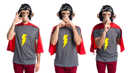 Superhero monkey man making silence gesture © luismolinero