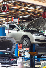 Cars waiting for repair at a mechanic auto garage.