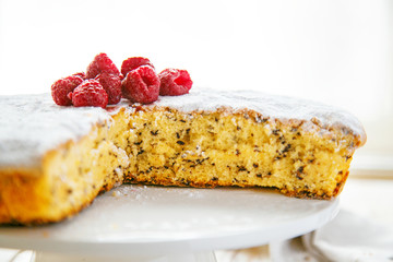Sponge cake wth raspberries on serving plate