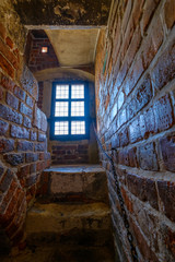 Fototapeta na wymiar Narrow staircase in a medieval castle