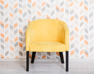 Yellow soft armchair in a room. Yellow color chair, modern design chair