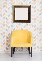 Concept mock up frame. Yellow soft armchair in a room. Yellow color chair, modern design chair. Contemporary room with empty frame and yellow arm-chair