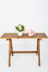 Bouquet of rose flowers on a wooden table