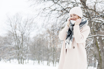 A young woman in a park full of snow