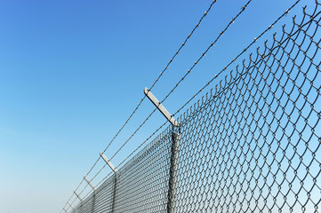iron chain link fence and blue sky