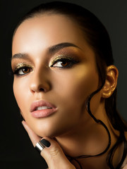 Woman with fashion golden makeup
