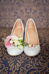 Bridal accessories: shoes and wedding bouquet or buttonhole. Wedding accessories: Bride's shoes and boutonniere