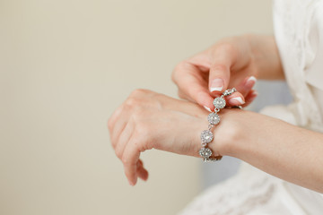 Bride's hands with simple manicure buttons bracelet - 134121292