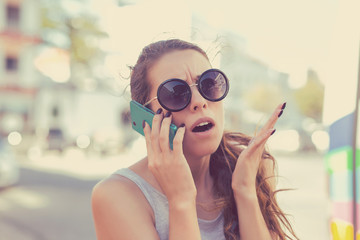 Frustrated woman talking on phone