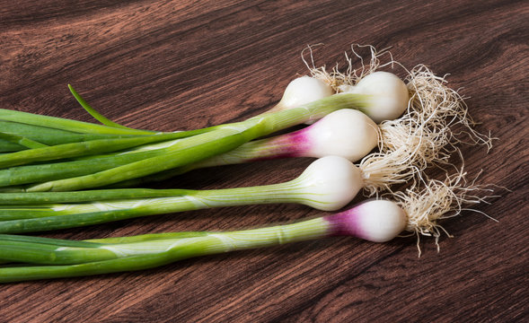 Spring Onions on wooden background