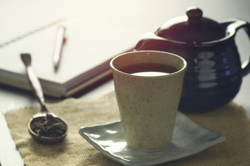 Hot tea cup on a frosty winter day on wood table background