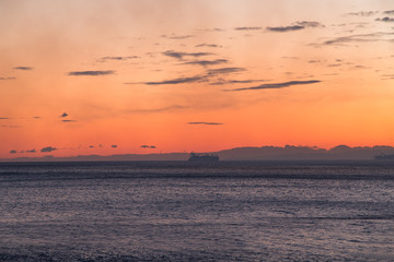 Ship on the horizon at sunset