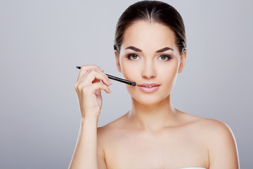 Fototapeta premium Model touching face with brush