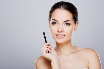 Fototapeta premium Girl holding with brush near face